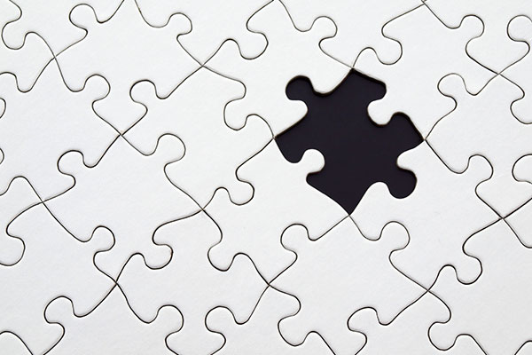 a white puzzle with one piece missing